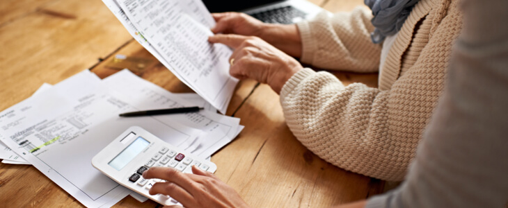 Cropped view of a senior woman receiving help with her finances from her granddaughter